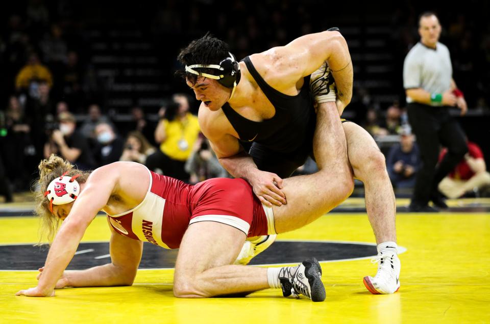 Iowa’s 285-pound star Tony Cassioppi cranks on Wisconsin’s Trent Hillger during a wrestling dual meet between in Iowa City, Iowa, on Saturday, Feb. 5, 2022.