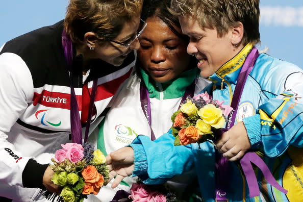 Silver medallist Cigdem Dede of Turkey, gold medallist Ivory Nwokorie of Nigeria and bronze medallist Lidiia Soloviova of Ukraine react on the podium during the medal ceremony for the women's -44kg powerlifting competition on day 2 of the London 2012 Paralympic Games at ExCel on August 31, 2012 in London, England. (Photo by Matthew Lloyd/Getty Images)