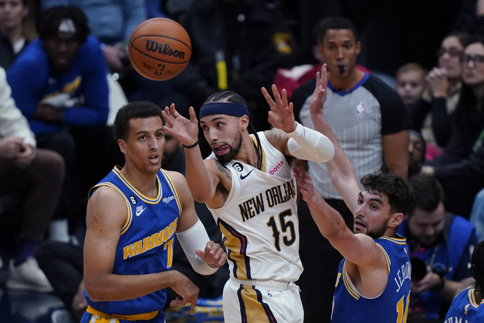 New Orleans Pelicans guard Jose Alvarado (15) passes between Golden State Warriors forward Patrick Baldwin Jr. (7) and guard Ty Jerome (10) in the second half of an NBA basketball game in New Orleans, Monday, Nov. 21, 2022. The Pelicans won 128-83. (AP Photo/Gerald Herbert)