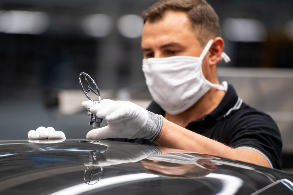 SINDELFINGEN, GERMANY - SEPTEMBER 02: A worker wearing a face mask assembles the new S-Class Mercedes-Benz passenger car at the new "Factory 56" assembly line at the Mercedes-Benz manufacturing plant on September 2, 2020 in Sindelfingen, Germany. The luxury car is the 11th generation S-Class and is scheduled to reach dealers in November. (Photo by Lennart Preiss/Getty Images)