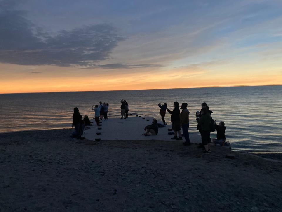 Visitors to Presque Isle State Park's Beach 1 take in the eclipsed-induced sunset at about 3:18 p.m. on Monday. A cheer went up from a crowd of hundreds when totality began and again when the sun reemerged.