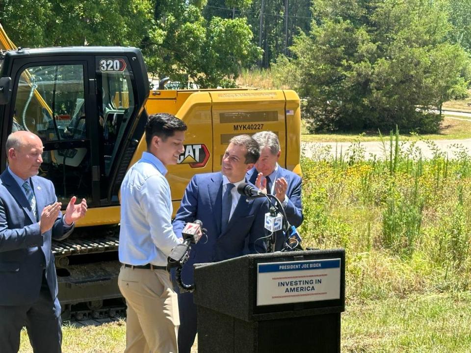 Santana Cruz Jr., center left, introduces U.S. Transportation Secretary Pete Buttigieg at a groundbreaking ceremony for a new bridge that will carry Durant Road over railroad tracks in North Raleigh, on Monday, July 1, 2024. Cruz’s company, Cruz Brothers Concrete of Graham, is a subcontractor on the project, part of a larger $1.3 billion effort to build a passenger rail line between downtown Raleigh and Wake Forest.