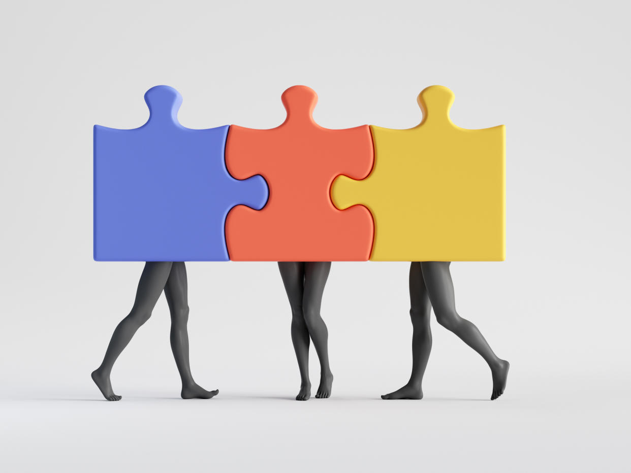  Three colorful puzzle pieces with mannequin legs attached together. 