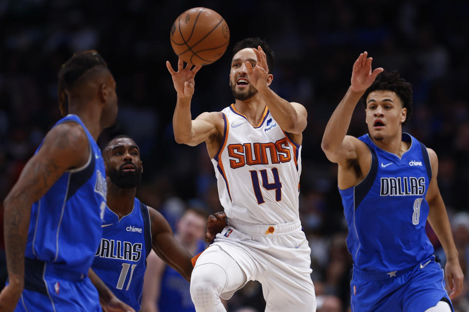 Phoenix Suns guard Landry Shamet (14) shoots during the first half of an NBA basketball game against the Dallas Mavericks, Thursday, Jan. 20, 2022, in Dallas. (AP Photo/Brandon Wade)