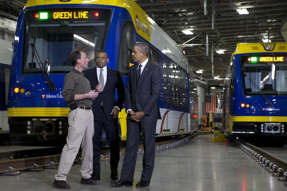 Mark Fuhrmann, New Start Program Director of Metro Transit, left, talks with President Barack Obama and Transportation Secretary Anthony Foxx, during a tour of the Metro Transit Light Rail Operations and Maintenance Facility in St. Paul, Minn., Wednesday, Feb. 26, 2014. In Minnesota Obama is expected to speak at Union Depot rail and bus station with a proposal asking Congress for $300 billion to update the nation's roads and railways, and about a competition to encourage investments to create jobs and restore infrastructure as part of the President’s Year of Action. (AP Photo/Jacquelyn Martin)