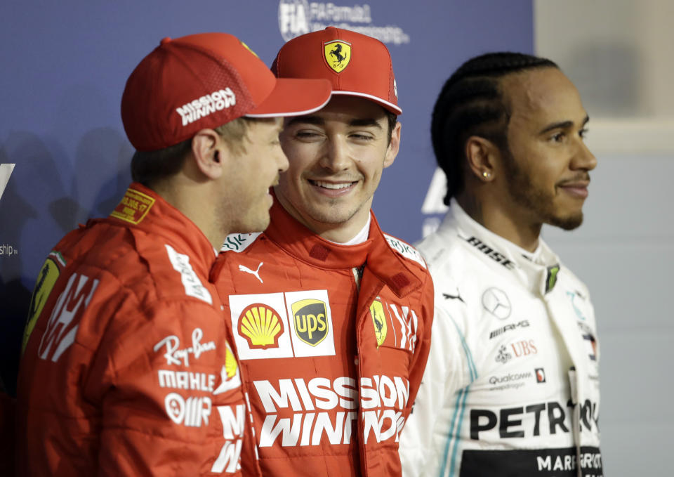 Ferrari driver Charles Leclerc of Monaco, center, celebrates his pole position with runner up Ferrari driver Sebastian Vettel of Germany, left and Mercedes driver Lewis Hamilton of Britain after the qualifying session at the Formula One Bahrain International Circuit in Sakhir, Bahrain, Saturday, March 30, 2019. The Bahrain Formula One Grand Prix will take place on Sunday. (AP Photo/Luca Bruno)