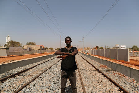 Cheikh Wane, 34, who said he lost his business because of a high speed rail project, speaks during an interview with Reuters in Mbao, on the outskirts of Dakar, Senegal February 12, 2019. Picture taken February 12, 2019. REUTERS/Zohra Bensemra