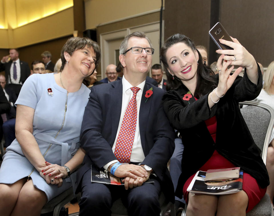 Democratic Unionist Party leader Arlene Foster, left, has her picture taken with party members Jeffrey Donaldson, MP, and Emma Littele-Pengelly, MP, at the party's annual conference in Belfast, Northern Ireland, Saturday, Oct. 26, 2019. (AP Photo/Peter Morrison)