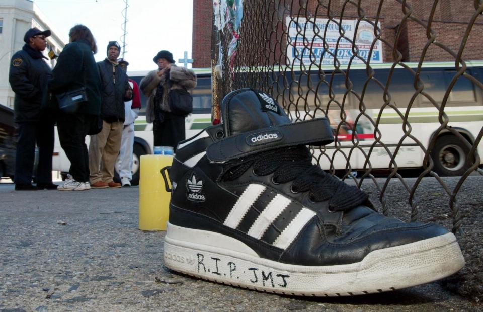 PHOTO: An Adidas sneaker bearing a message sits on the street outside a music studio in Queens, New York, on Oct.31, 2002, where former Run-DMC member Jason Mizell, who was also known as DJ Jam Master Jay, was shot and killed Oct. 30. (Matt Campbell/AFP via Getty Images, FILE)