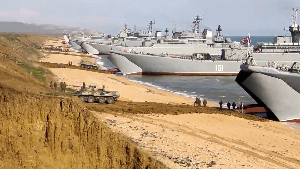 FILE - This frame from a video released on April 23, 2021, by Russian Defense Ministry Press Service shows, Russian troops board landing vessels after drills in Crimea. Ukrainian and Western officials are worried that a Russian military buildup near Ukraine could signal plans by Moscow to invade its ex-Soviet neighbor. The Kremlin insists it has no such intention and has accused Ukraine and its Western backers of making the claims to cover up their own allegedly aggressive designs. (Russian Defense Ministry Press Service via AP, File)