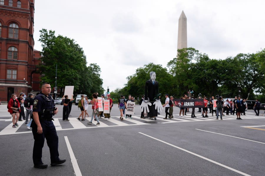 A large effigy of Israeli Prime Minister Benjamin Netanyahu, center, is seen as protestors attempt to block streets, Wednesday, July 24, 2024, in Washington, ahead of a scheduled visit by Netanyahu at the U.S. Capitol. The Washington Monument is seen, rear.(AP Photo/Mike Stewart)