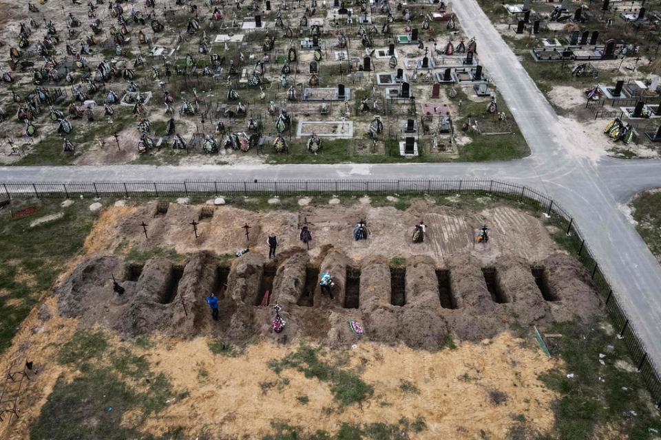 Aerial picture taken on April 18, 2022 of coffins being buried in Bucha (AFP via Getty Images)