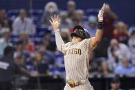 San Diego Padres' Fernando Tatis Jr. reacts as he crosses the plate with a solo home run during the first inning of a baseball game against the Miami Marlins, Saturday, July 24, 2021, in Miami. (AP Photo/Lynne Sladky)