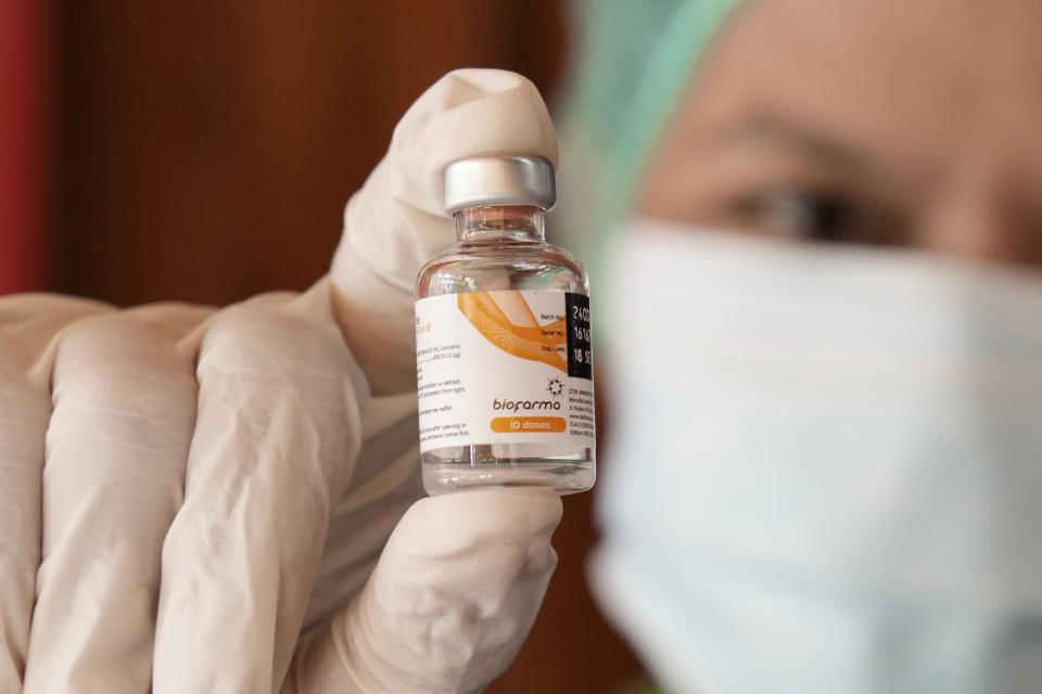 A health worker shows a vial of the Sinovac COVID-19 vaccine manufactured by the Indonesian pharmaceutical company Biofarma, during a mass vaccination in Jakarta, Indonesia, Monday, June 21, 2021. Indonesia's president ordered authorities to speed up the country's vaccination campaign as the World Health Organization warned of the need to increase social restrictions in the country amid a fresh surge of coronavirus infections caused by worrisome variants. (AP Photo/Dita Alangkara)