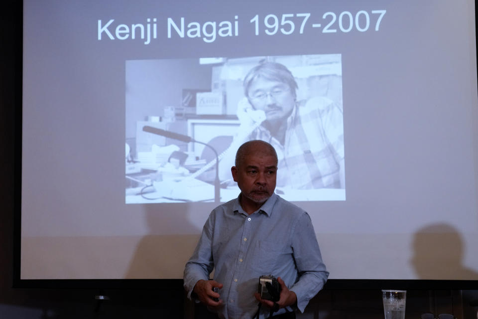 Aye Chan Naing from Democratic Voice of Burma holds the video camera of slain Japanese journalist Kenji Nagai before handing over to his sister Noriko Ogawa, at the Foreign Correspondents Club in Bangkok, Thailand Wednesday, April 26, 2023. Nagai's video camera, which he had been carrying when he was shot dead covering a during a street protest in Myanmar September 2007, was missing until it was recently recovered by the Democratic Voice of Burma news service, which handed it over to his sister at the club. (AP Photo/Sakchai Lalit)