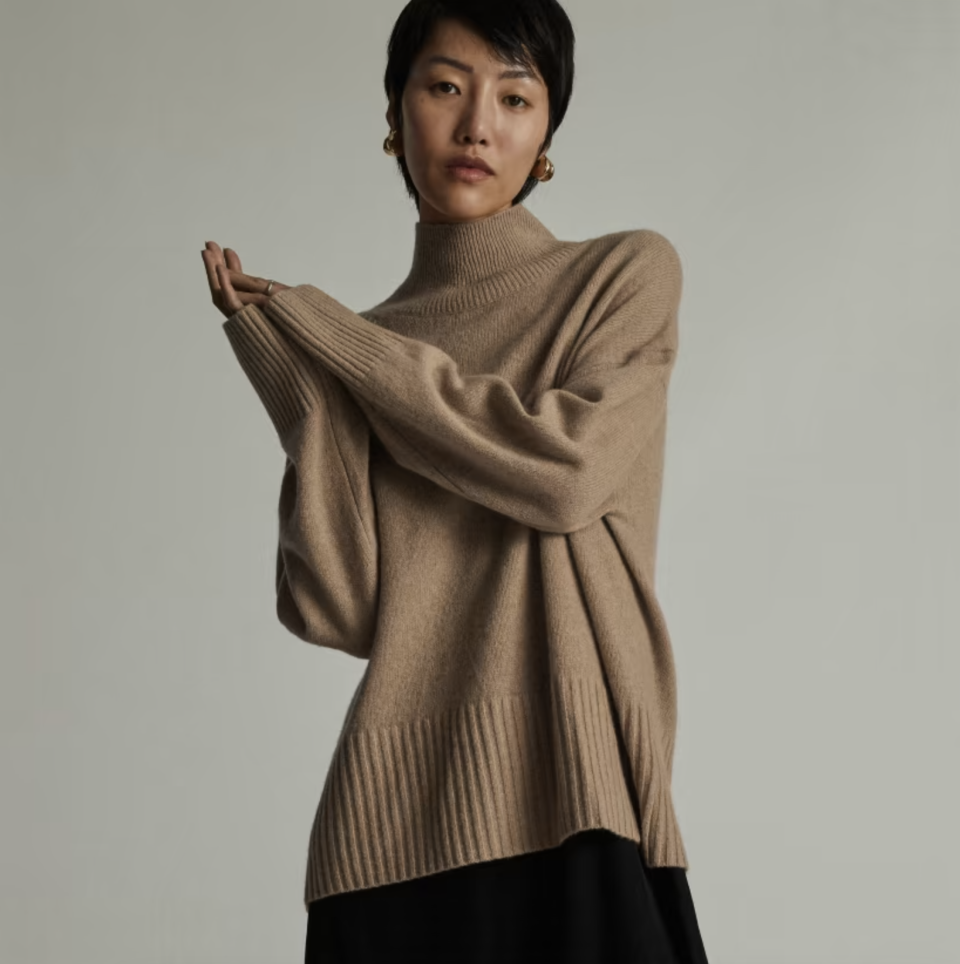 model wearing light camel The Cashmere Oversized Turtleneck. Photo via Everlane.