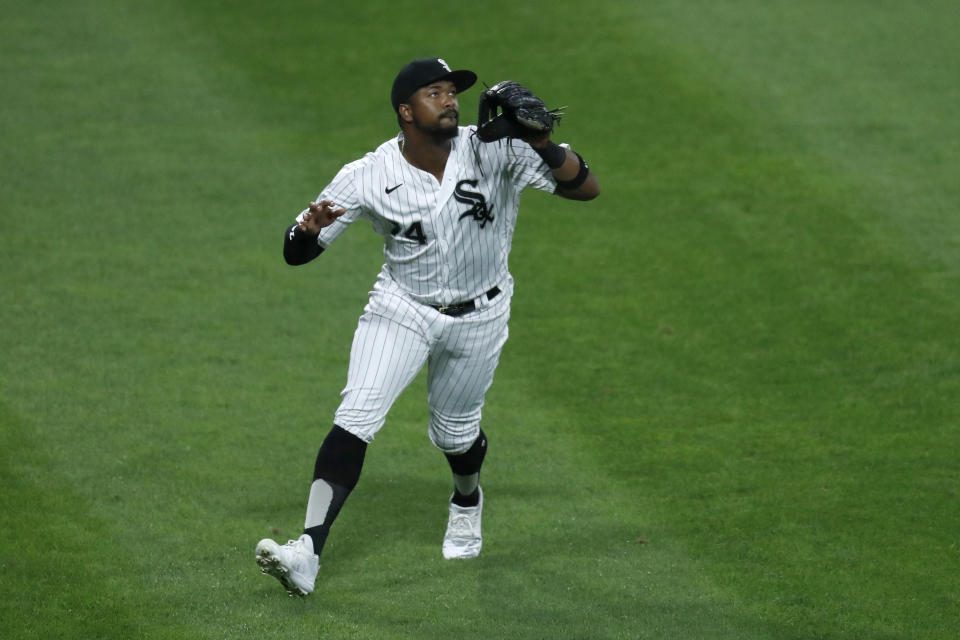 Chicago White Sox left fielder Eloy Jimenez keeps an eye on a fly ball during the fifth inning of a baseball game against the Cleveland Indians Friday, Aug. 7, 2020, in Chicago. (AP Photo/Charles Rex Arbogast)