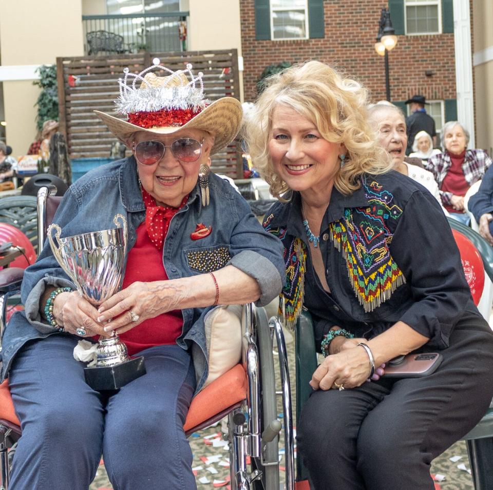 From left, "Bootsie" Kawa and her daughter Linda Frazee smile for the cameras at Independence Village of Brighton Village after Kawa won her first-place prize in a talent competition for her yodeling skills.