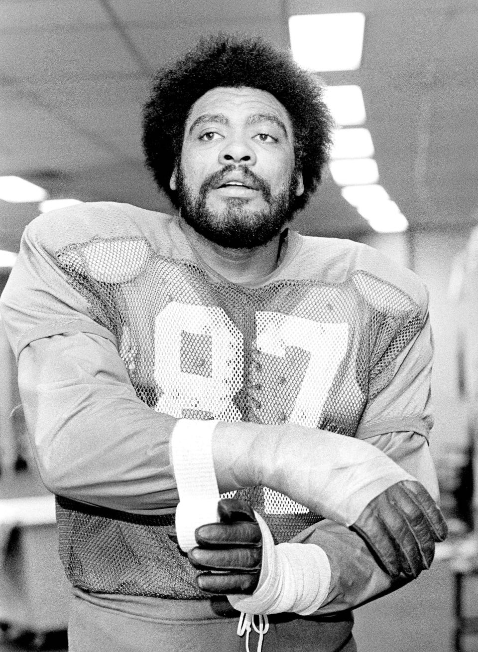 FILE - Philadelphia Eagles defensive end Claude Humphrey wraps his wristin the locker room before Eagles practice session in Philadelphia, on Dec. 20, 1979. Humphrey, a Pro Football Hall of Famer Claude and one of the NFL's most fearsome pass rushers during the 1970s, died unexpectedly in Atlanta on Friday night, Dec. 3, 2021, according to the Hall of Fame, which was informed of his death by his daughter. He was 77. (AP Photo/Gene Puskar, File)