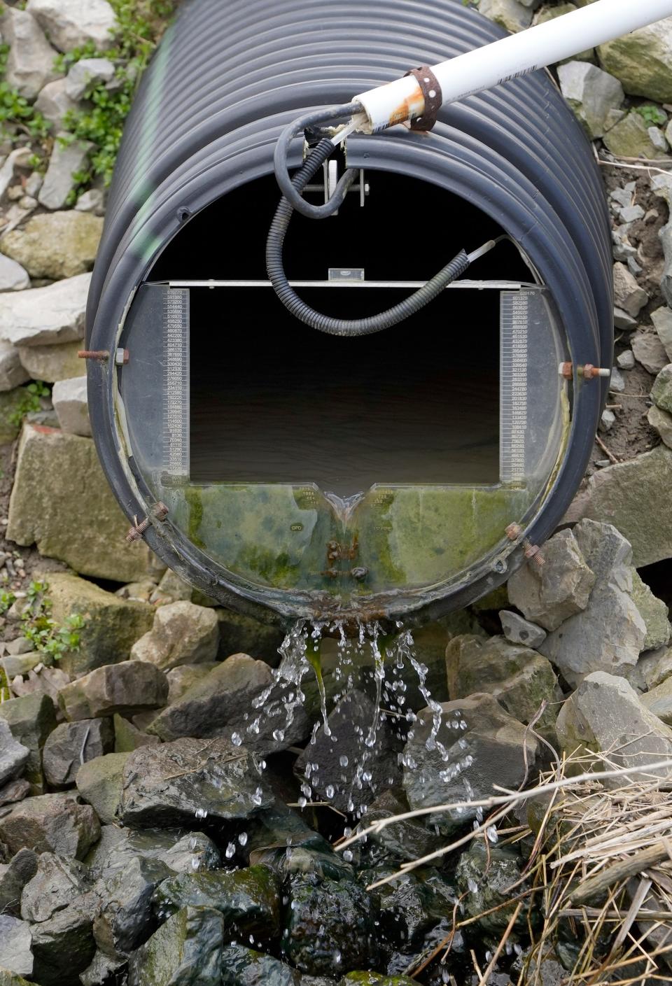 Water drains from an underground pipe on Duane Stateler's farm in McComb which features a testing system developed by the USDA that measures nitrogen, phosphorus and potassium in water from surface run-off water as well as from the tile drainage below the surface.