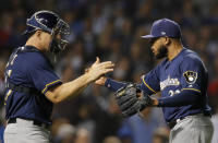 Milwaukee Brewers' Jeremy Jeffress, right and Milwaukee Brewers' Erik Kratz celebrate their team's win over the Chicago Cubs during their baseball game Monday, Sept. 10, 2018, in Chicago. (AP Photo/Jim Young)