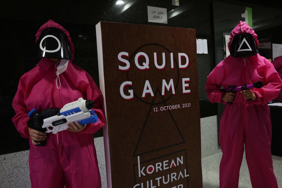 Participants take part in an event where they play the games of Netflix smash hit "Squid Game" at the Korean Cultural Centre in Abu Dhabi, on October 12, 2021. - A dystopian vision of a polarised society, "Squid Game" blends a tight plot, social allegory and uncompromising violence to create the latest South Korean cultural phenomenon to go global. (Photo by Giuseppe CACACE / AFP) (Photo by GIUSEPPE CACACE/AFP via Getty Images)