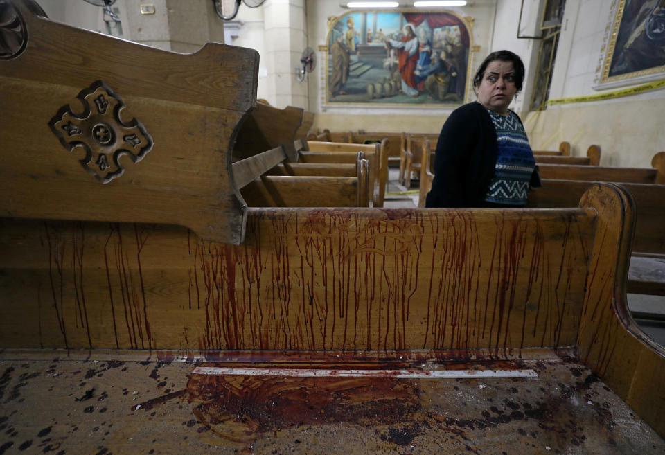 <p>APR. 9, 2017 – A woman stands near a pew covered in blood inside a Coptic church that was bombed in Tanta, Egypt. Islamic State claimed responsibility for the attacks, which more than 44 were killed and injured more than 100 people and occurred a week before Coptic Easte.r (Photo: Mohamed Abd El Ghany/Reuters) </p>