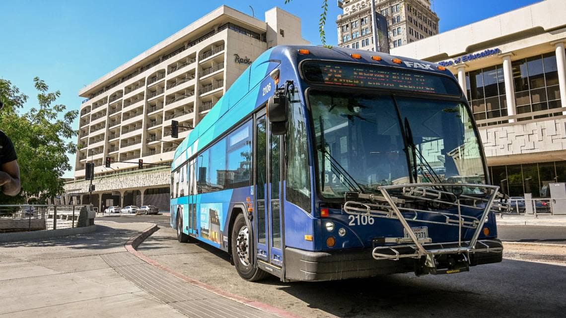 A Fresno FAX bus pulls into the Downtown Transit Center on Van Ness Avenue in front of the Fresno County Courthouse on Tuesday, Aug. 15, 2023.