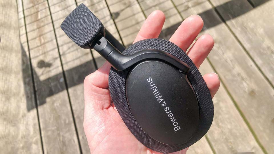 Bowers & Wilkins PX7 S2 close up headphones held in hand of reviewer