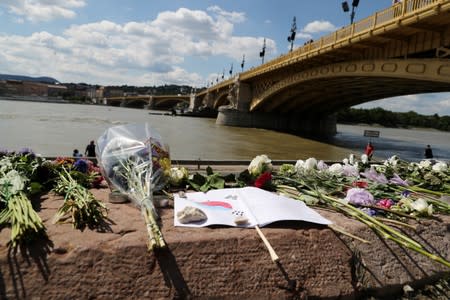 Flowers are seen placed next to the Margaret bridge in respect for the victims from a boat carrying South Korean tourists capsized on the Danube river, in Budapest