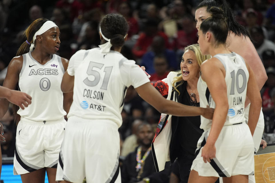 Las Vegas Aces head coach Becky Hammon speaks with her players during the second half of a WNBA basketball game against the Phoenix Mercury, Tuesday, May 14, 2024, in Las Vegas. (AP Photo/John Locher)