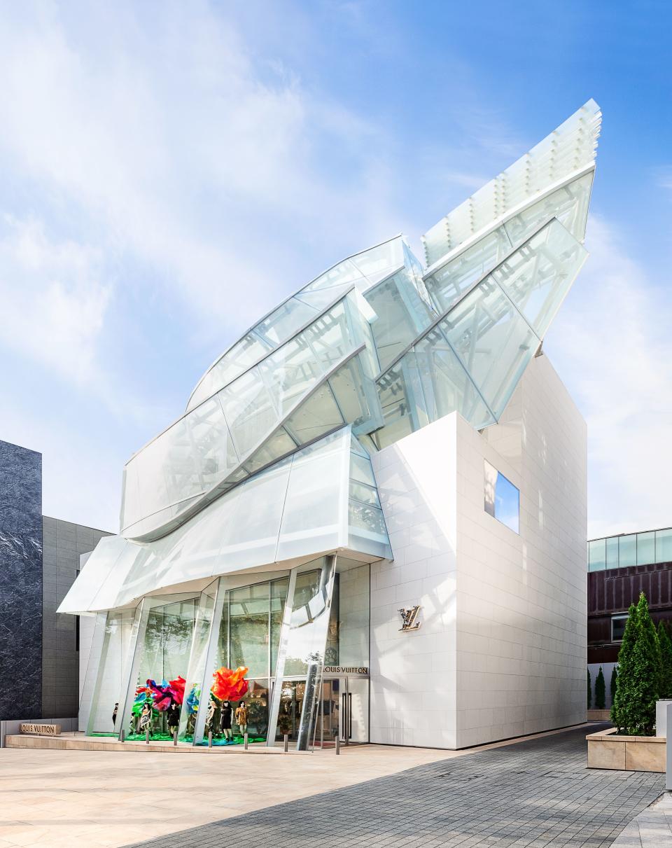 Gehry’s glass panels crown the façade.