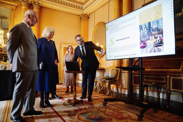 <p>Victoria Jones - WPA Pool/Getty</p> Queen Camilla and King Charles are presented with the coronation roll at Buckingham Palace on May 1, 2024