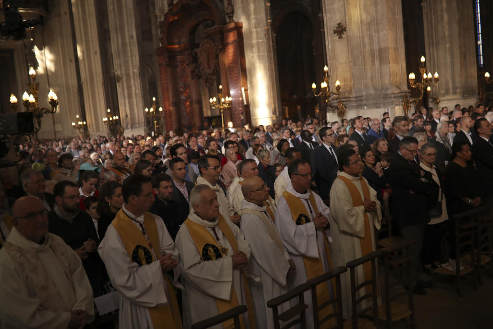 Faithfuls attend a Sunday Mass at the grandiose Saint-Eustache church on the Right Bank of the Seine river in Paris, Sunday, April 21, 2019. The archbishop of Paris and Catholics from around France and the world honored the firefighters who saved Notre Dame Cathedral, praying Sunday at a special Easter Mass for a swift reconstruction of the beloved monument. (AP Photo/Francisco Seco)