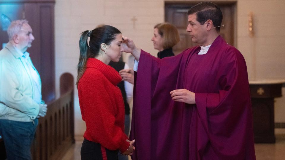 Father Jon Thomas administers ashes to Maria Piscopo of Haddonfield during an Ash Wednesday Mass held at Christ the King Roman Catholic Church in Haddonfield on Wednesday, February 14, 2024.