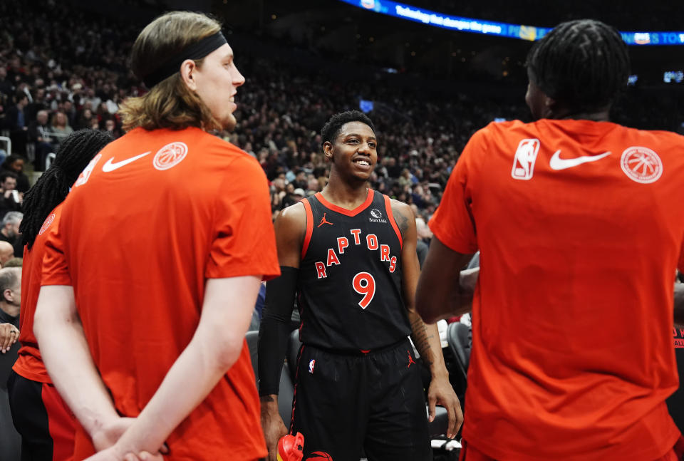 Toronto Raptors' RJ Barrett (9) chats with teammates Kelly Olynyk, left, and Chris Boucher during a break in the first half of the team's NBA basketball game against the Houston Rockets on Friday, Feb. 9, 2024, in Toronto. (Frank Gunn/The Canadian Press via AP)