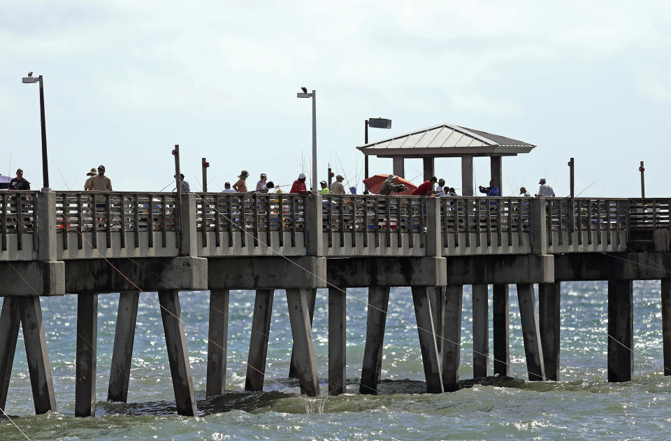 A group of people fishing at Dania Beach Pier on Saturday, August 31, 2019 at Dania Beach in Florida. As of the 11 a.m. advisory, Hurricane Dorian is a category 4 storm. (David Santiago/Miami Herald via AP)