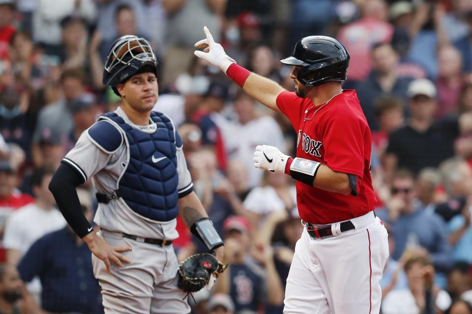 Boston Red Sox's Kevin Plawecki, right, celebrates his solo home run in front of New York Yankees' Gary Sanchez during the third inning of a baseball game, Saturday, Sept. 25, 2021, in Boston. (AP Photo/Michael Dwyer)