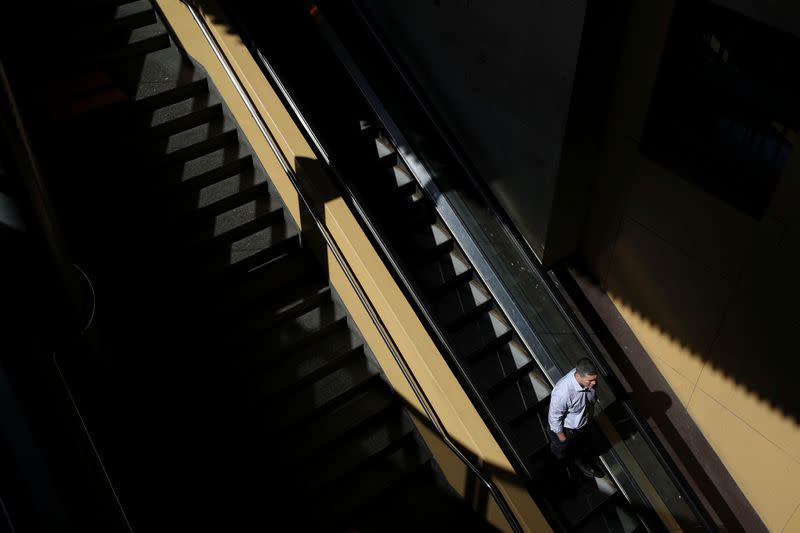 A man uses an escalator at Sydney Central railway station during a workday following the implementation of stricter social-distancing and self-isolation rules to limit the spread of the coronavirus disease (COVID-19) in Sydney