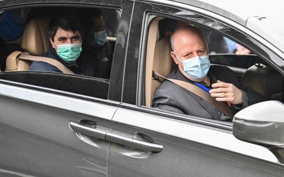 Peter Daszak (R), Vladimir G. Dedkov( L) and other members of the WHO team investigating the origins of the Covid-19 coronavirus, leave the Hubei Center for animal disease control and prevention -  Hector RETAMAL / AFP