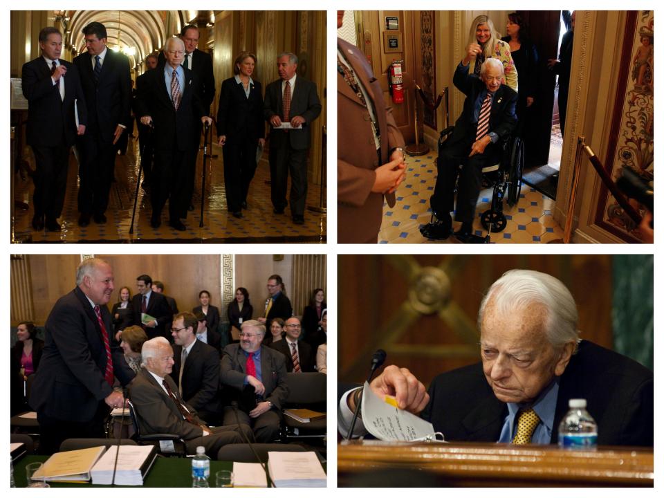 Democratic Sen. Robert Byrd of West Virginia (center) leads home state lawmakers, including then-Democratic Gov. Joe Manchin (second from left) and then-Republican Rep. Shelley Moore Capito (second from right) through the US Capitol in January 2006; Scheduler Martha McIntosh pushes wheelchair-bound Democratic Sen. Robert Byrd of West Virginia towards a Senate floor vote in August 2009; An aide pushes wheelchair-bound Democratic Sen. Robert Byrd of West Virginia into an Appropriations Committee markup in July 2008; Democratic Sen. Robert Byrd of West Virginia reads opening remarks from pages displaying lines printed in a huge font during a 2005 hearing on Capitol Hill.