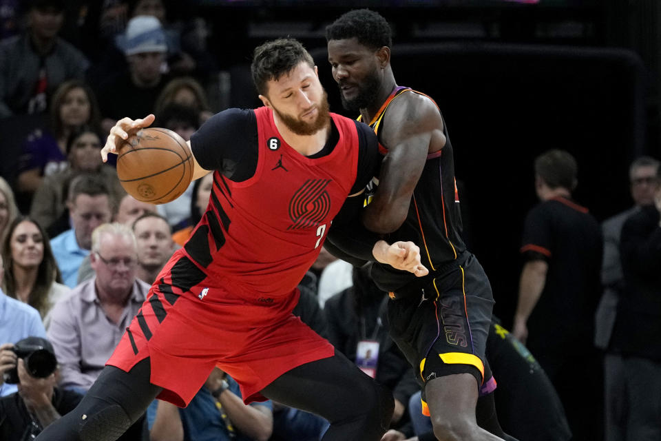 Portland Trail Blazers center Jusuf Nurkic is fouled by Phoenix Suns center Deandre Ayton, right, during the second half of an NBA basketball game, Friday, Nov. 4, 2022, in Phoenix. (AP Photo/Matt York)