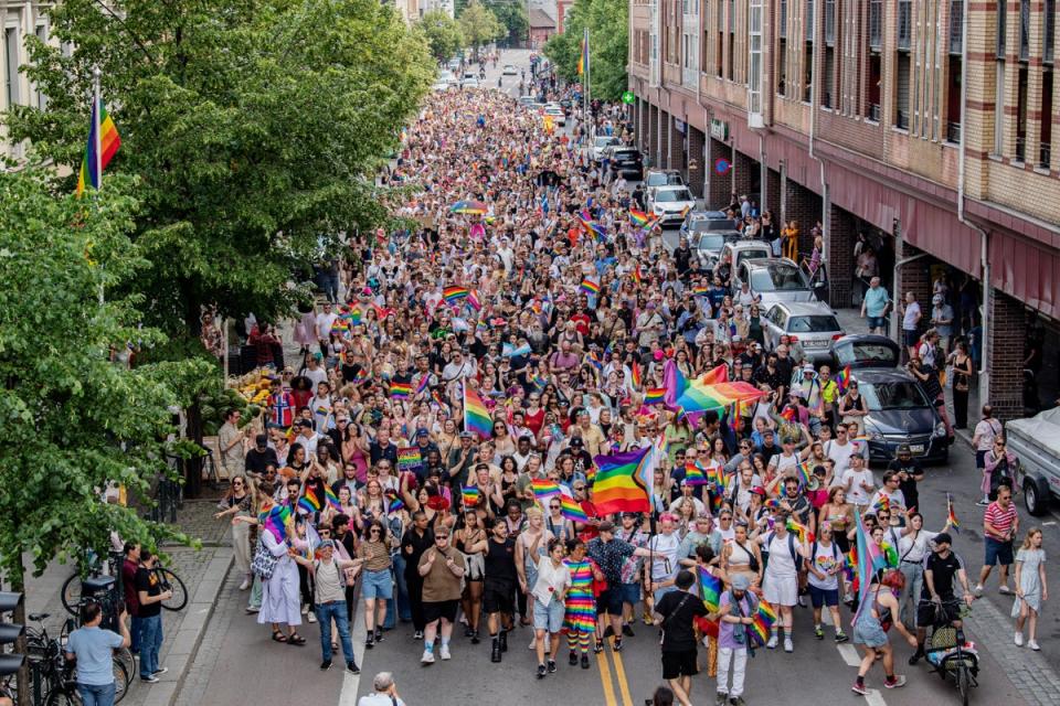 Hundreds of people lined the streets, carrying Pride flags (Getty Images)