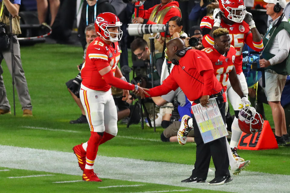 MIAMI GARDENS, FL - FEBRUARY 02:  Kansas City Chiefs Quarterback Patrick Mahomes (15) shakes hands with Kansas City Chiefs offensive coordinator Eric Bieniemy after scoring a touchdown  during the first quarter of Super Bowl LIV on February 2, 2020 at Hard Rock Stadium in Miami Gardens, FL.  (Photo by Rich Graessle/PPI/Icon Sportswire via Getty Images)