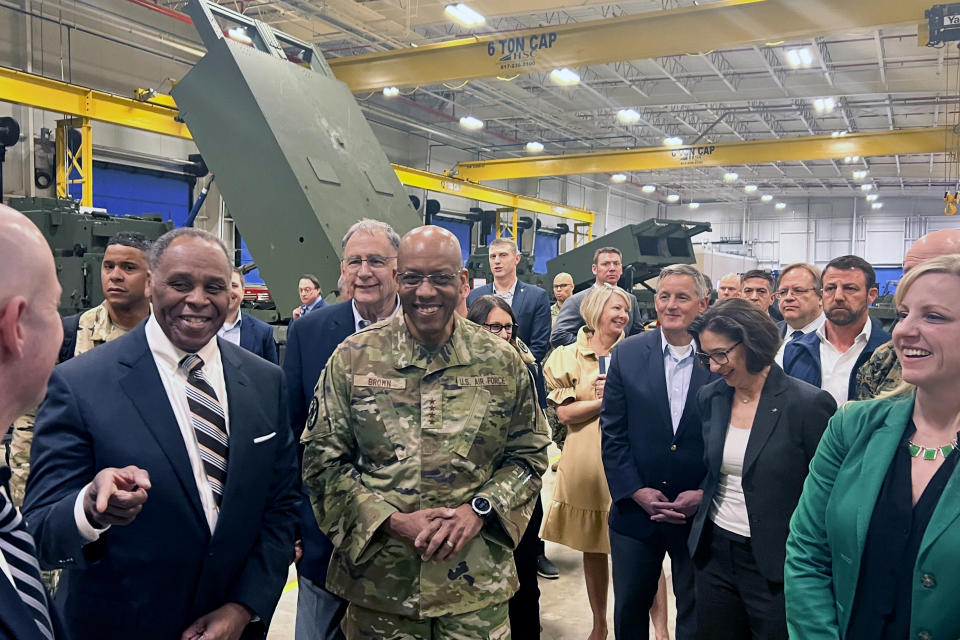 Joint Chiefs Chairman Gen. CQ Brown, center, tours the HIMARS production line at Lockheed Martin's Camden, Ark. facility Thursday, March 14, 2024, with Sen. John Bozeman, R-Ark., left. (AP Photo/Tara Copp)