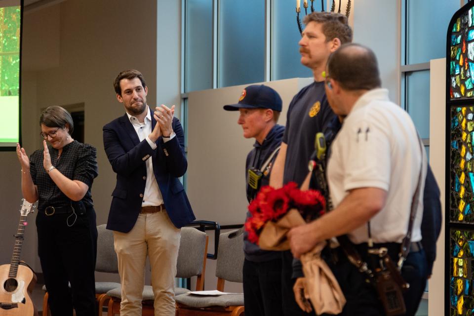 Members of the Austin Fire Department receive a standing ovation Wednesday from members of Congregation Beth Israel for their part in putting out the fire that damaged the synagogue in 2021.