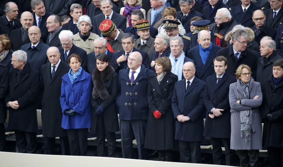 Members of the French government, French politicians, officials and guests attend a ceremony to pay a national homage to the victims of the Paris attacks at Les Invalides monument in Paris, France, November 27, 2015. L to R, first row : French National Assembly speaker Claude Bartolone, French Foreign Minister Laurent Fabius, Environment Minister Segolene Royal, Education Minister Najat Vallaud-Belkacem, Finance Minister Michel Sapin, Health Minister Marisol Touraine, Interior Minister Bernard Cazeneuve, Economy Minister Emmanuel Macron, State Reform Minister Marylise Lebranchu and Sports Minister Patrick Kanner. (REUTERS/Jacky Naegelen)