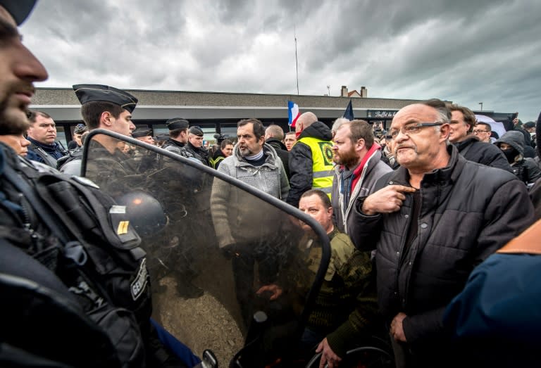 Policemen disperse supporters of the Pegida movement (Patriotic Europeans Against the Islamisation of the Occident) during a demonstration in Calais, northern France on February 6, 2016