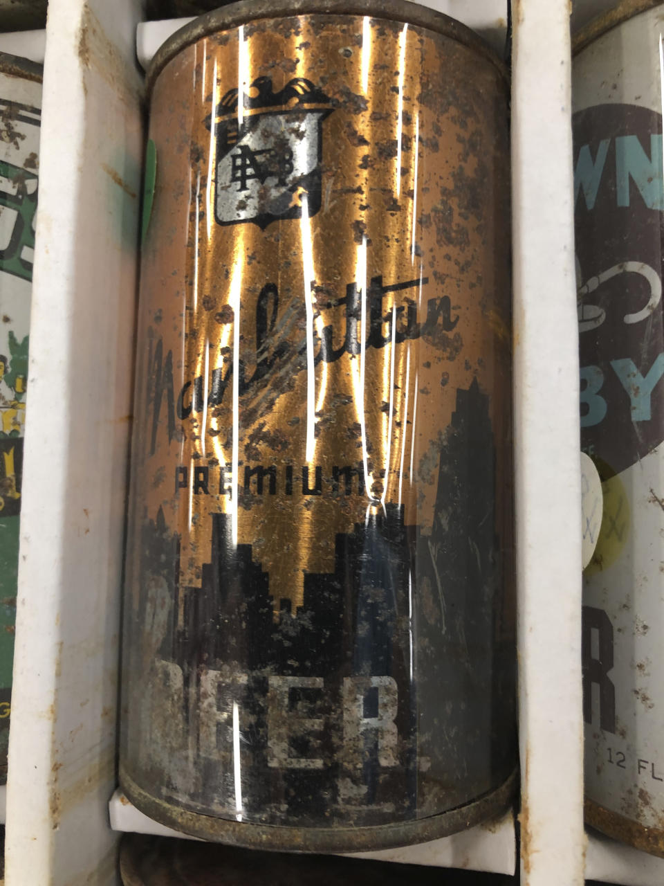 A 1930s-era beer can from the Manhattan Brewing Company, connected with mobster Al Capone, sits on display Thursday, Aug. 29, 2019, in Albuquerque, N.M., at the 49th annual gathering of members of the Brewery Collectibles Club of America. Collectors from around the world began Thursday buying, trading and selling containers of brews at the annual four-day event billed the "CANvention." (AP Photo/Russell Contreras)
