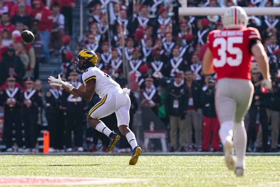 Michigan receiver Cornelius Johnson catches a touchdown pass.